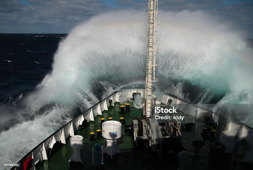 Big wave rolling over snout of the ship Big wave rolling over the snout of the ship Ship Stock Photo