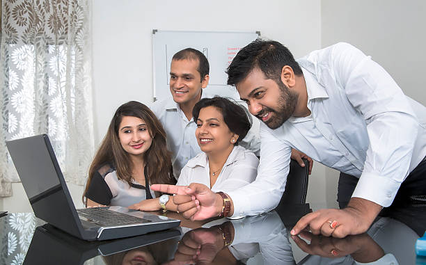 Young and cheerful Business team in a brainstorming session. stock photo
