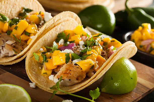 Homemade Baja Fish Tacos Homemade Baja Fish Tacos with Mango Salsa and Chips baja california peninsula stock pictures, royalty-free photos & images