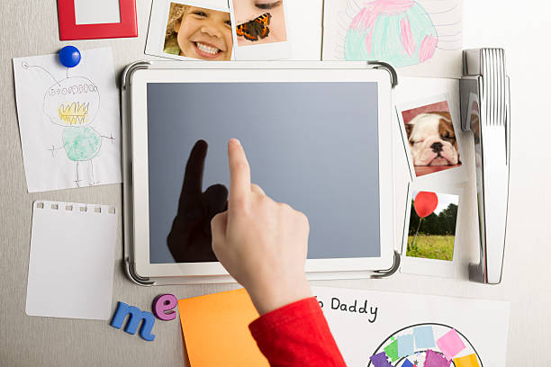 istock Finger touches digital touch screen tablet on a refrigerator door 491789191