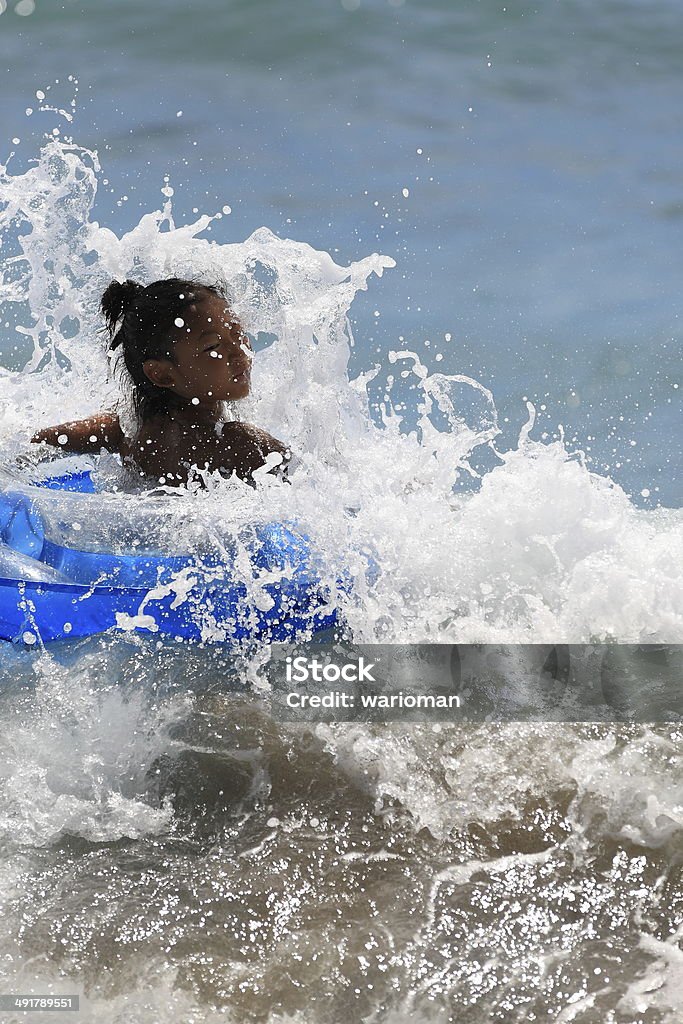 Float Boy play with wheel floating in the sea. 10-11 Years Stock Photo