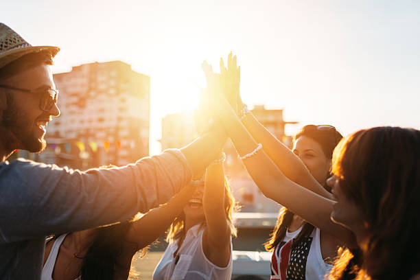 istock Happy friends at the rooftop doing high five 491790110