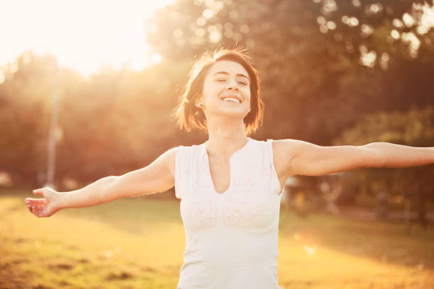 istock Happy young woman with outstretched arms 491790264