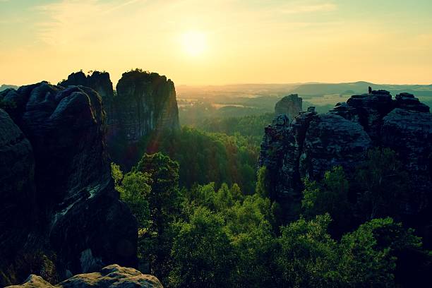istock lighted rocks and hills bellow sunset on  horizon. Dark silhouettes. 491791762