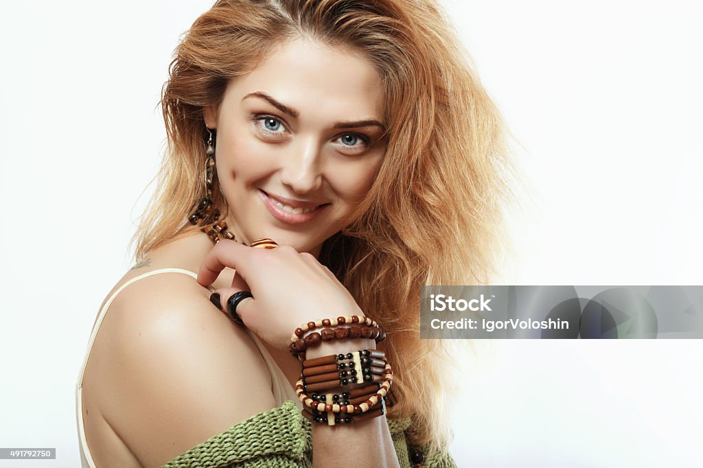 Happy and beautiful girl with the decorations on the hands beautiful and happy blonde with a thin wooden decorations on the hands and neck Beauty Stock Photo
