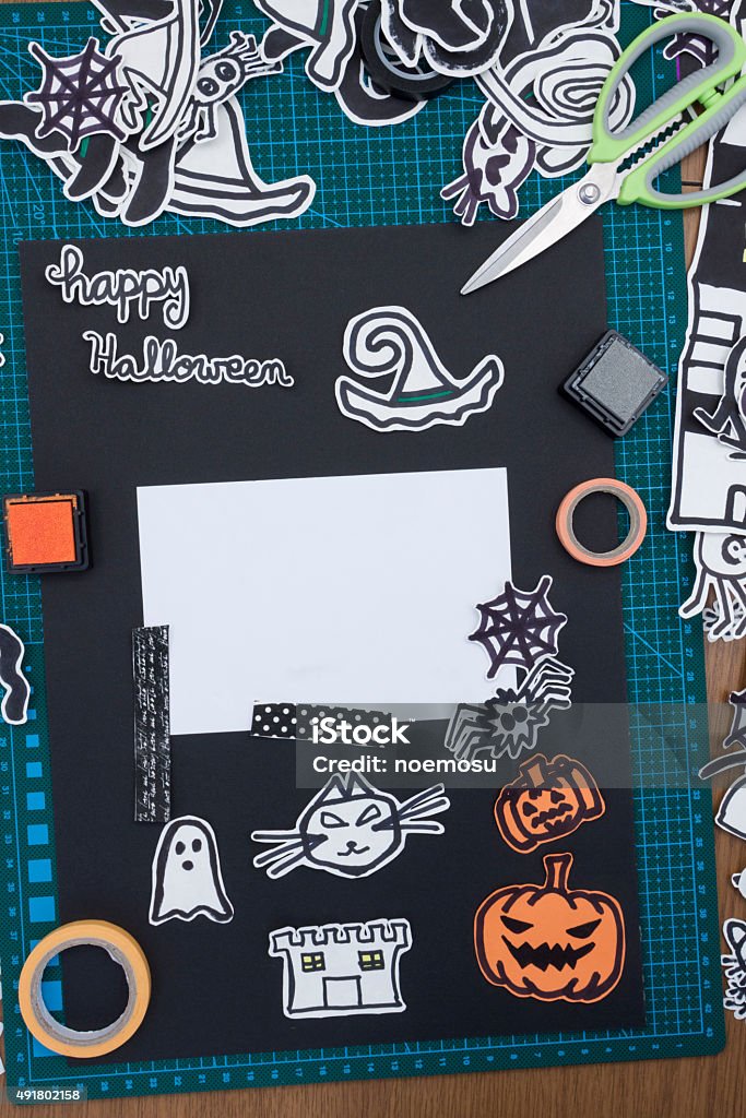 Halloween Scrapbook layout a vertical overhead view of a Halloween scrapbook layout with decorations and the materials needed 2015 Stock Photo