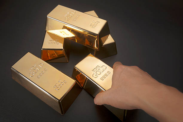 istock Hand holding gold bar 491803658