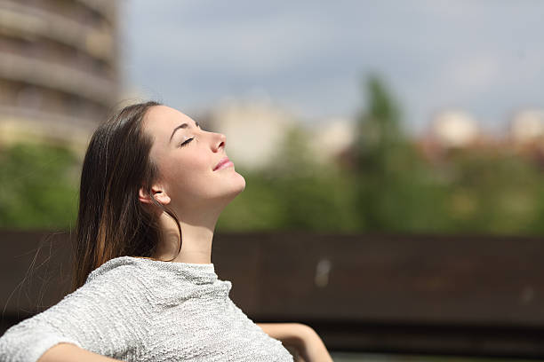istock Urban woman breathing deep fresh air 491803848