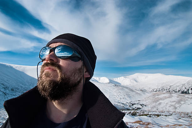 istock Man with glasses and a beard in the snowy mountains 491804252