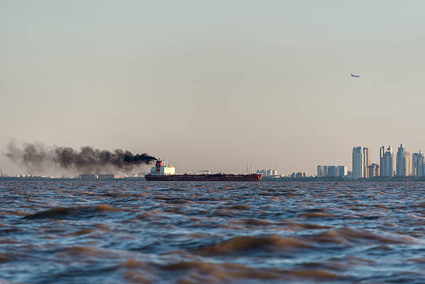 steamboat on Alster Lake in Hamburg, Germany with cityscape in background during sunset