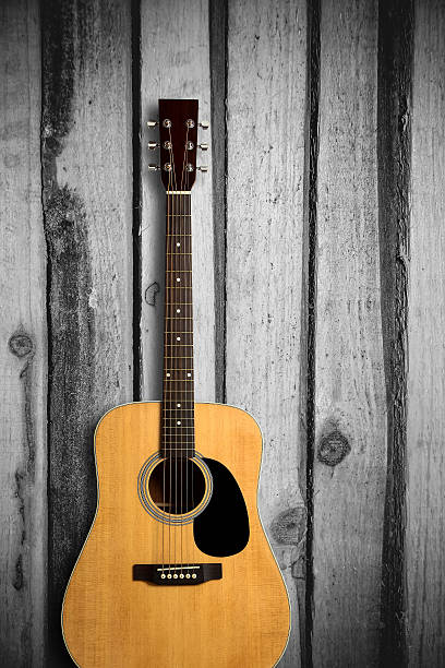 istock Acoustic guitar on wooden background 491805168