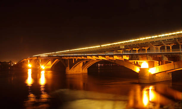 istock Lightening of road bridge reflected in river at night 491805500