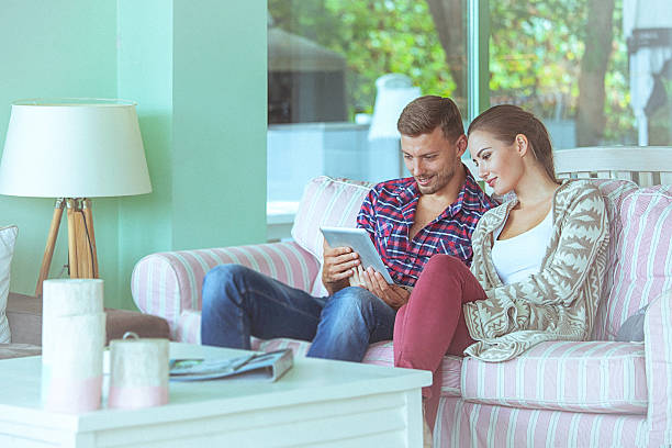 istock Young loving couple using digital tablet at cafe 491806932