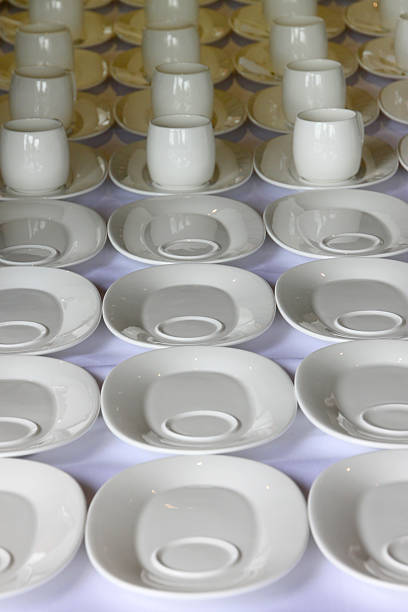 istock rows of white cup and saucer on table 491812052
