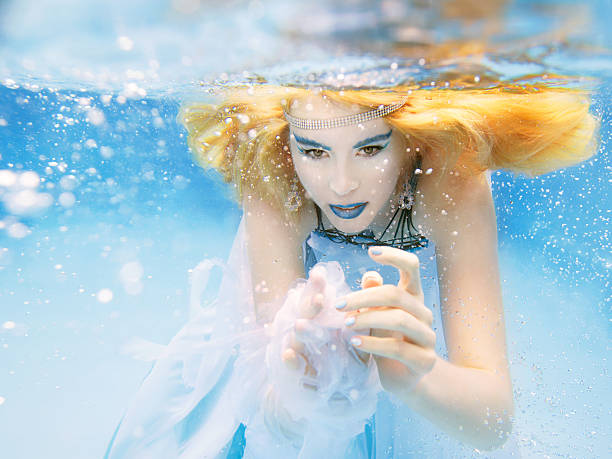 istock blonde young beautiful woman as air element underwater 491816682