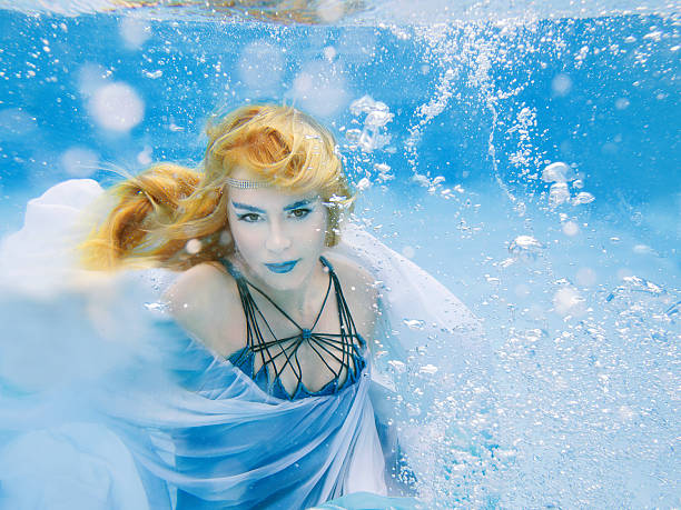 istock blonde young beautiful woman as air element underwater 491816718