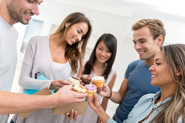 istock Friends celebrating a birthday and eating cupcakes 491817224