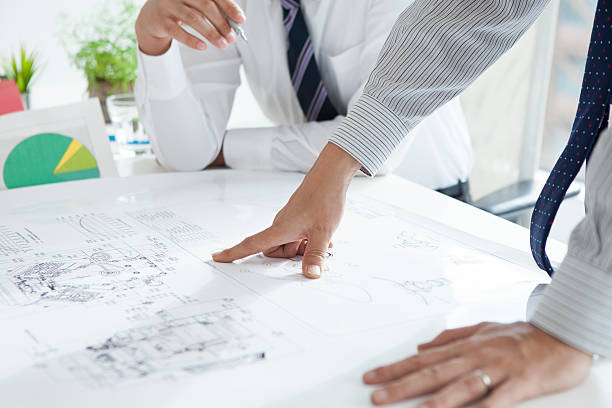 istock Businessmen pointing at a drawing in the office 491824658