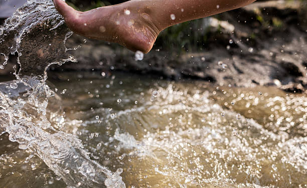 istock Unrecognizable woman's leg splashing water. 491825188