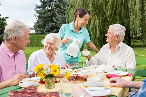 istock Group of elderly people sitting at the garden table 491826846
