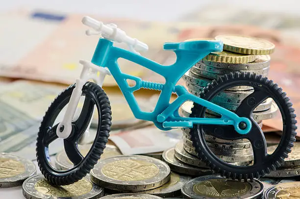 toy bicycle, banknotes and coins