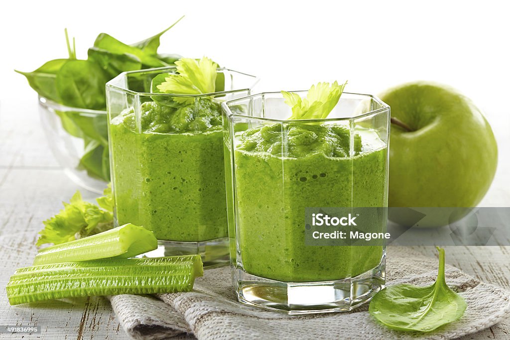 Green smoothies in glasses on wooden table glass of green smoothie on wooden table Apple - Fruit Stock Photo