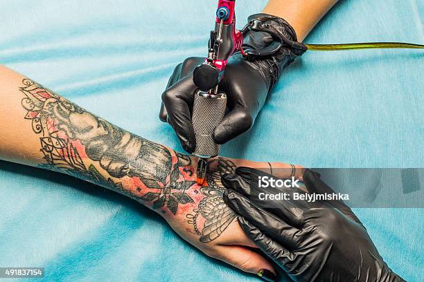 Tattooist Demonstrate The Process Tattoo On Hand Stock Photo - Download Image Now - Tattoo, Tattooing, Tattoo Machine