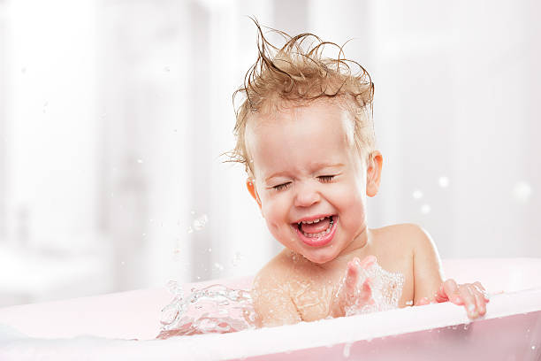 happy funny  baby  laughing and bathed in bath happy funny baby  laughing and bathed in the bath froth decoration stock pictures, royalty-free photos & images