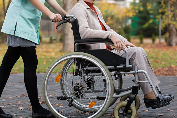 istock Lady on wheelchair and nurse 491838019