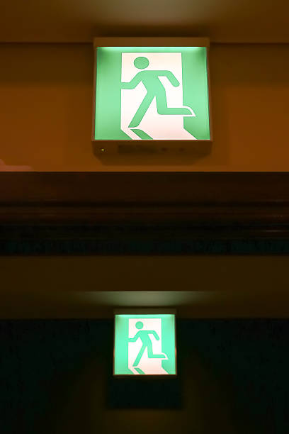 istock green emergency exit sign showing the way to escape 491838651