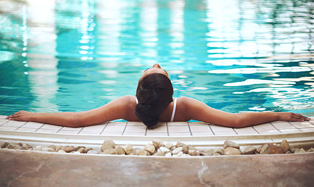 Sublime serenity Shot of a young woman relaxing in the pool at a spahttp://195.154.178.81/DATA/i_collage/pi/shoots/805701.jpg indulgence stock pictures, royalty-free photos & images