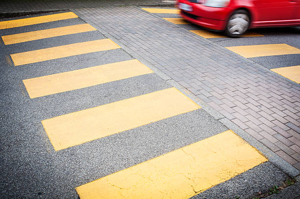 istock Red Car Passing On Pedestrian Crossing 491839357