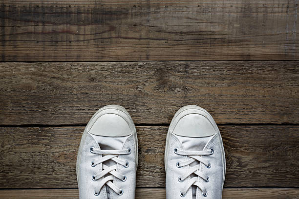 istock white shoes on wooden background 491842122