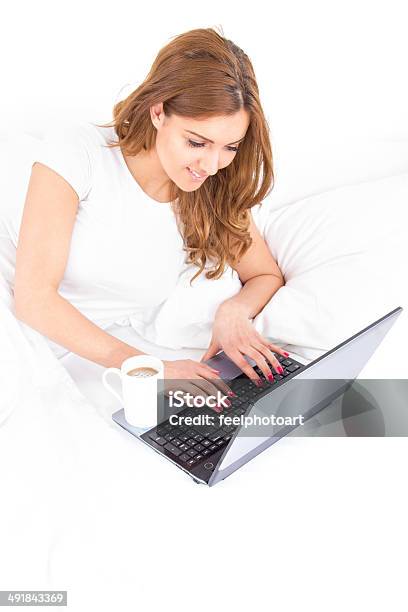 Woman Typing On Laptop Computer At Home In The Morning Stock Photo - Download Image Now