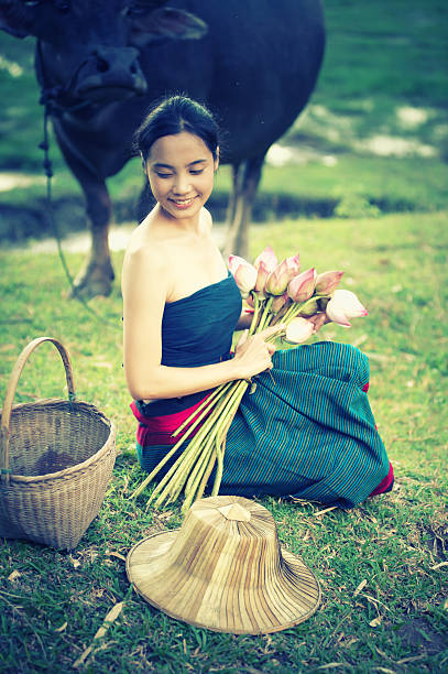 istock thai ancient young women with buffalo on rural 491843660