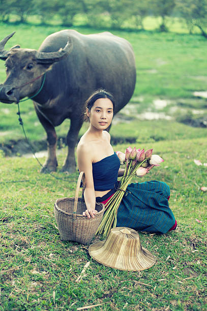 istock thai ancient young women with buffalo on rural 491843848