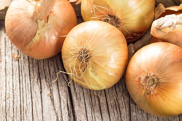 istock Fresh onions on wooden table 491851860