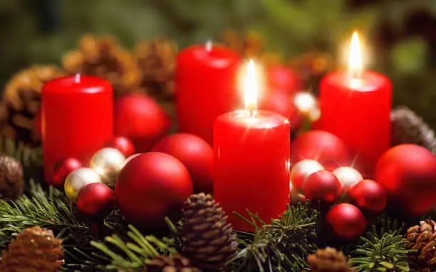 Studio shot of a nice advent wreath with baubles and two burning red candles