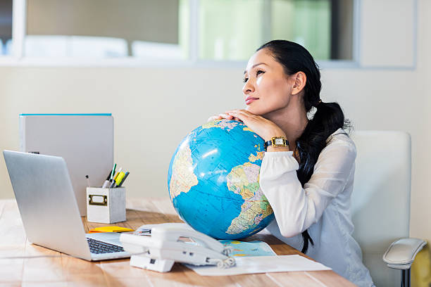 istock Pretty businesswoman holding globe 491855202