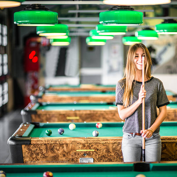 istock Happiness girl standing in a pub at the pool table 491855646