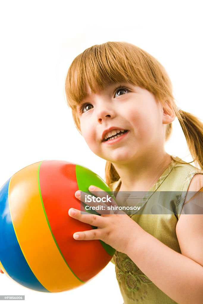 Playing with ball Vertical image of cute girl with ball in her hands isolated on white background    Note to inspector: the image is pre-Sept 1 2009 2015 Stock Photo