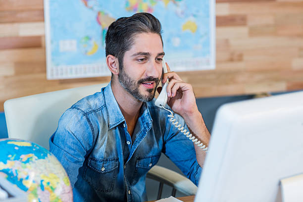 istock Smiling travel agent having phone call 491856048