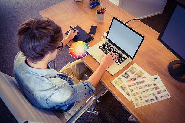 istock Happy designer working on his laptop 491856350