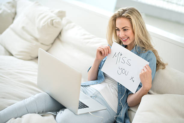 istock Woman video chatting with her distant boyfriend 491856782