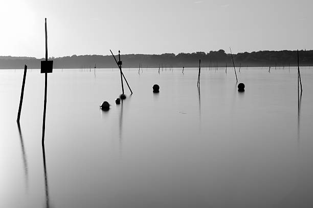 Fishing Grounds View of a fishing ground, photogrphed with a longish exposure. Picture is Black/White großunternehmen stock pictures, royalty-free photos & images