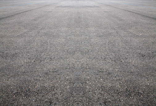 White lines dividing a freshly laid road.