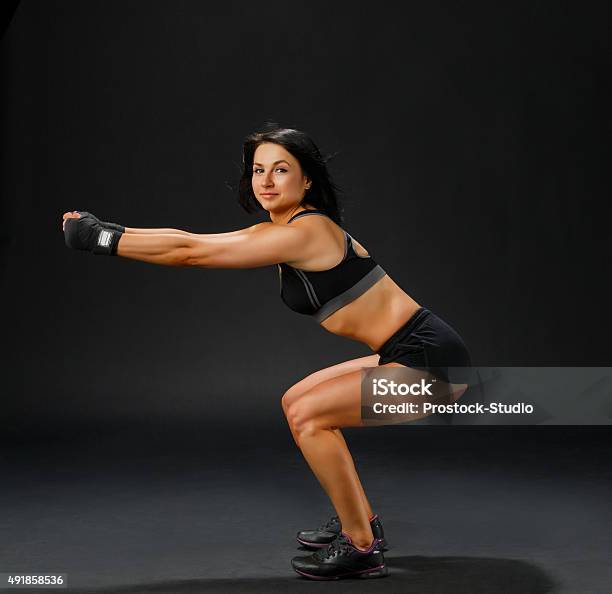 Woman In Black Fitness Suit Doing Squatting Stock Photo - Download Image Now - 2015, Active Lifestyle, Activity