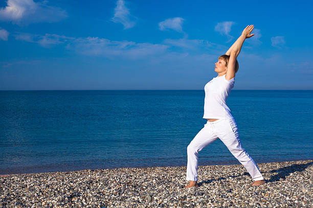 istock Yoga woman doing exercises at the seafront. 491870839