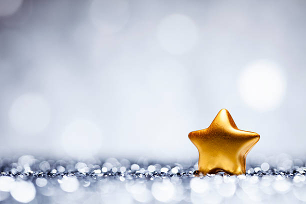 Christmas Star - Glitter Lights Bokeh Defocused Decoration White Blue Glittery christmas decorations. Defocused lights in the background. Photo captured with a Canon EF 100mm F/2.8L at f4.0.  christmas star shape christmas lights blue stock pictures, royalty-free photos & images