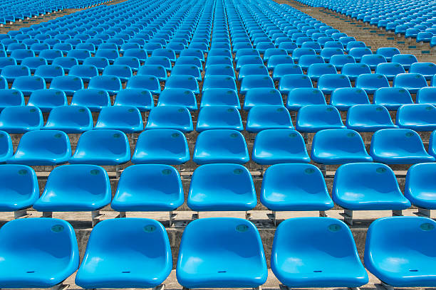 Field of empty blue plastic stadium seats.